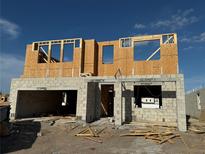 Image of a house under construction with concrete block base and wood framing, capturing the early stages of development at 809 River Stone Trl, Sanford, FL 32771
