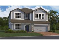 Charming two-story home with stone accents, a two-car garage, and well-maintained landscaping at 809 River Stone Trl, Sanford, FL 32771