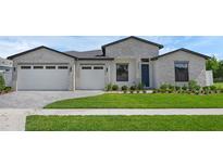 Beautiful single Gathering home featuring a lush lawn, brick facade, and a two car garage at 9265 Eagles Perch Pl, Orlando, FL 32825