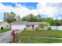 Charming single-story home with well-maintained lawn and mature trees at 11435 Aries Dr, Orlando, FL 32837