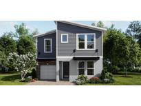 Beautiful two-story home with gray siding, stone accents, and a well-manicured lawn at 1217 Reunion Village Blvd, Kissimmee, FL 34746