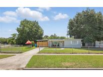 Charming single-story home featuring a fenced yard, picnic table, and cozy outdoor space at 1301 Lawne Blvd, Orlando, FL 32808