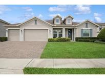 Charming one-story home featuring a three-car garage and well-manicured front lawn at 1835 Southern Red Oak Ct, Ocoee, FL 34761