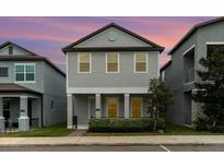 Charming two-story home featuring a symmetrical design and manicured front yard, offering an inviting curb appeal at 1997 Standing Rock Cir, Oakland, FL 34787
