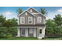Charming two-story home featuring board and batten siding, a metal roof, and a welcoming front porch at 2054 Education St, St Cloud, FL 34771