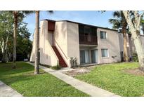 Two-story condo featuring a private balcony with a staircase and well-maintained green space at 2514 Citrus Club Ln # 308, Orlando, FL 32839