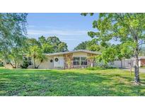 Charming single-story home with well-manicured lawn, stone accents, and welcoming front entrance at 2524 Sweetwater Trl, Winter Park, FL 32789
