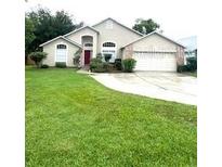 Charming one-story home features a well-manicured lawn and attached two-car garage at 300 Churchill Dr, Longwood, FL 32779
