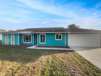Charming single-story home with a well-manicured lawn and a two-car garage at 3321 Crimson Ln, Deltona, FL 32738