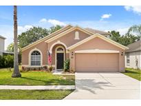 Charming single-story home with a well-manicured lawn and a two-car garage at 4249 Andover Cay Blvd, Orlando, FL 32825