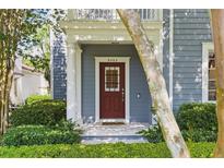 Charming home featuring a red front door, manicured landscaping, and a welcoming entrance at 5262 Baskin St, Orlando, FL 32814