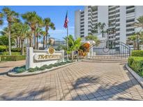 Community sign for Tradewinds with stone pillar, brick pavers, and the Tradewinds sign at 5275 S Atlantic Ave # 506, New Smyrna Beach, FL 32169