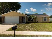 Charming single Gathering home featuring a well-manicured front yard and solar panels at 5547 Garden Grove Cir, Winter Park, FL 32792