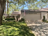 Charming home features a two-car garage and lush landscaping in a well-maintained community at 650 Woodridge Drive, Fern Park, FL 32730