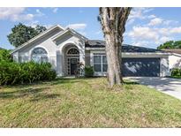 Charming single-story home with a well-maintained lawn and beautiful front yard landscaping at 1013 Silcox Branch Cir, Oviedo, FL 32765