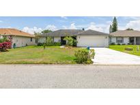 Charming single-story home featuring an attached two-car garage and well-maintained front yard at 11811 Scarecrow Ln, Orlando, FL 32821