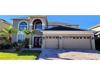 Stunning two-story home with a well-manicured lawn, lush landscaping, and a convenient two-car garage at 12126 Diedra Ct, Orlando, FL 32825