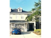 Two-story home boasting attached garage, well-manicured landscaping, and neutral color scheme in desirable community at 14033 Turning Leaf Dr, Orlando, FL 32828