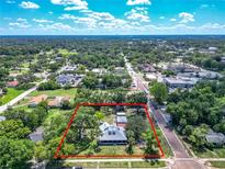 Expansive aerial view of this property with a large lot surrounded by mature trees and neighborhood streets at 141 S Central Ave, Apopka, FL 32703