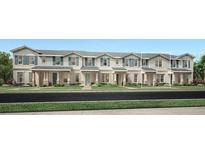 Charming row of new two-story townhomes, each boasting unique architectural details and manicured lawns at 1828 Crowncrest Dr, Apopka, FL 32703