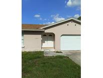 Traditional one-story home featuring a beige exterior, arched entryway and attached single car garage at 2087 Allegheny Ct, Orlando, FL 32818