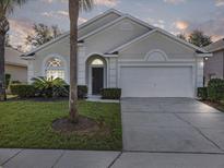 Charming single-story home with a well-maintained lawn, mature landscaping, and a two-car garage at 2115 Morning Star Drive, Clermont, FL 34714