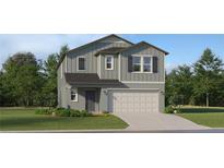 Charming two-story home with neutral gray siding, a two-car garage, and well-maintained landscaping at 2409 Bluestone Rd, Haines City, FL 33844