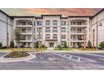 Stylish condominium exterior with balconies and manicured landscaping against a beautiful sunset sky at 4013 Breakview Dr # A407, Orlando, FL 32819