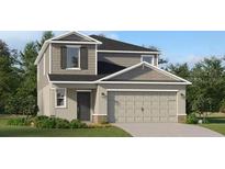 Charming two-story home showcasing a gray color scheme, attached two-car garage, and professionally landscaped yard at 4082 Old Mill Rd, Haines City, FL 33844