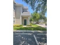 Inviting home exterior featuring a well-maintained lawn and assigned parking spaces at 417 Southern Pecan Cir # 201, Winter Garden, FL 34787