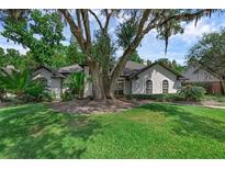 Charming single-story home featuring stucco exterior, mature landscaping, and a well-manicured lawn at 460 W Palm Valley Dr, Oviedo, FL 32765
