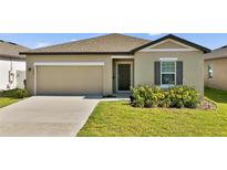 Charming single-story home featuring a well-maintained lawn and a two-car garage at 5857 Beefmaster Rd, St Cloud, FL 34771