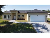 Charming single-Gathering home with well-maintained lawn, gray roof, and attached two-car garage at 6741 Heavitree Dr, Sebring, FL 33876