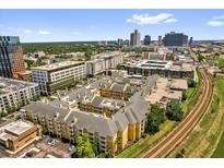 Stunning aerial view of the apartment complex surrounded by city skyline and lush greenery with easy access to transport links at 860 N Orange Ave # 306, Orlando, FL 32801