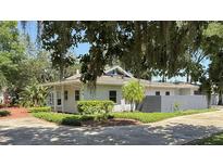 Charming one-story home featuring a unique roofline, mature landscaping, and a well-manicured lawn at 954 N Texas Ave, Orlando, FL 32804