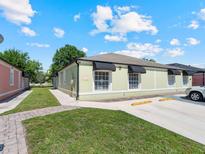 Charming single story home with a well-manicured lawn and black awnings, offering a welcoming curb appeal at 1064 Universal Rest Pl, Kissimmee, FL 34744