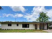 Charming single-story home featuring a covered front porch and fresh white paint at 1326 Edmundshire Ln, Orlando, FL 32806