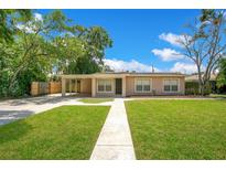 Charming one-story home features a well-manicured lawn and convenient covered parking at 1531 Huntington St, Lakeland, FL 33801