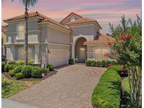 Elegant home featuring a barrel tile roof, manicured landscaping, and a paver driveway at 1638 Whitney Isles Dr, Windermere, FL 34786