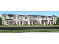 Charming new construction townhome with white siding, black roof, and manicured lawn at 1664 Crowncrest Dr, Apopka, FL 32703