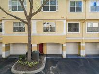 Two-story condo with a garage and a red front door at 1810 Shadow View Cir # 1810, Maitland, FL 32751
