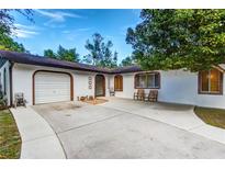 Welcoming single-story home boasts a brick-accented facade and a convenient attached garage at 205 Elaine Pl, Chuluota, FL 32766