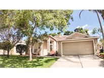 Charming single Gathering home featuring a well maintained lawn and a two car garage at 2343 Walnut Heights Rd, Apopka, FL 32703