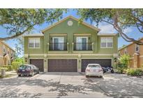 Three-story townhouse with balconies over garages and mature landscaping around the property at 2430 Little Gem Loop, Sanford, FL 32773