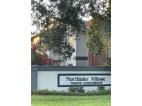 Northlake Village Private Condominium complex with a sign and mature landscaping at 25306 Northlake Dr # 25306, Sanford, FL 32773