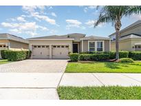 Charming single-story home featuring a well-manicured lawn and a two-car garage at 4737 Maple Park St, Orlando, FL 32811