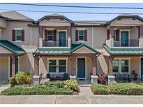 Charming townhouse featuring a cozy front porch and beautiful landscaping at 5119 Jones Rd, St Cloud, FL 34771