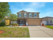 Charming two-story home with a screened in porch and a two car garage in a residential neighborhood at 5151 Preserve Blvd, St Cloud, FL 34772
