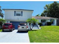 Charming two-story home featuring a well-maintained lawn and a freshly painted garage door at 656 Little Wekiva Rd, Altamonte Springs, FL 32714