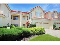Beautiful home featuring a tile roof, a two car garage, and immaculate landscaping at 6941 Piazza St, Orlando, FL 32819